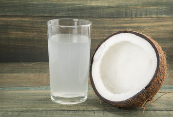 Coconut and water on wooden background