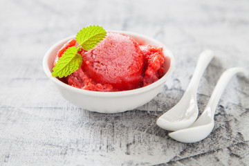 ice cream, red sorbet with strawberry on a concrete background, selective focus