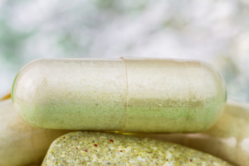 Mixed natural food supplement pills, multivitamin and glucosamine capsules, macro image.