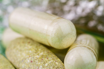 Mixed natural food supplement pills, multivitamin and glucosamine capsules, macro image.