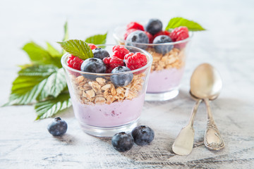 yogurt and muesli with berries on a table, selective focus,