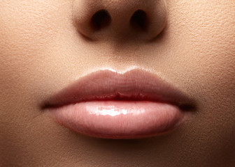 Face part. Beautiful female lips with natural makeup, clean skin. Macro shot of female lip, clean skin. Fresh kiss. Spa beauty cosmetics