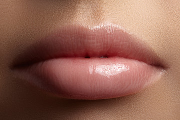Face part. Beautiful female lips with natural makeup, clean skin. Macro shot of female lip, clean...