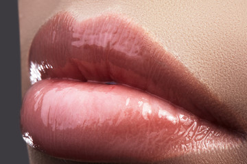 Face part. Beautiful female lips with natural makeup, clean skin. Macro shot of female lip, clean skin. Fresh kiss. Spa beauty cosmetics