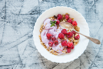 yogurt and muesli with berries on a table, selective focus, top view