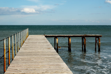 Fototapeta premium Old wooden bridge to the sea