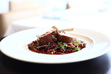 Lamb rack with pickled beetroot and black lentil ragout