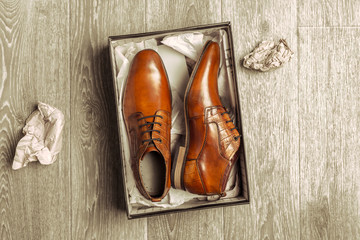 Fashion concept with male shoes on wooden background