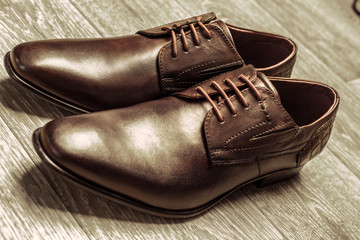 Fashion concept with male shoes on wooden background