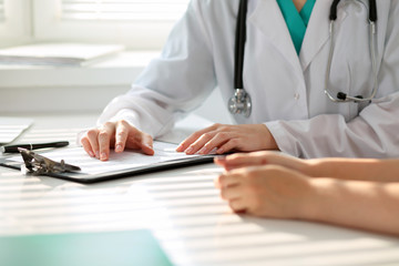 Doctor and patient are discussing something, just hands at the table