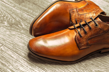 Fashion concept with male shoes on wooden background