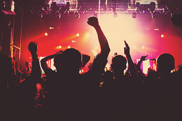 silhouettes of a massive crowd at the party concert club music happy