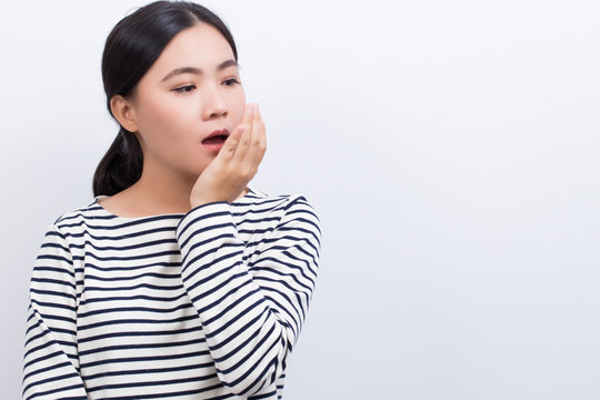 Woman Checking Her Breath By Her Hand