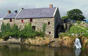 Obraz premium Historic stone built corn mill with water wheel and race in County Down, Northern Ireland
