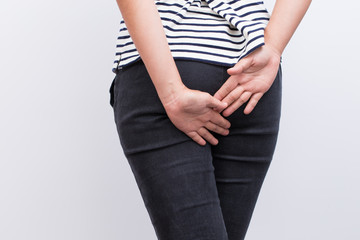 Woman has diarrhea holding her butt