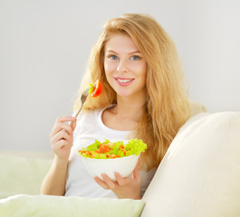 Young woman with green salad