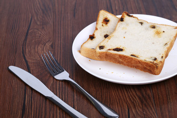French toast on a white plate with  fork.