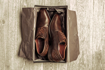 Fashion concept with male shoes on wooden background