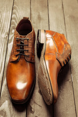 Fashion concept with male shoes on wooden background