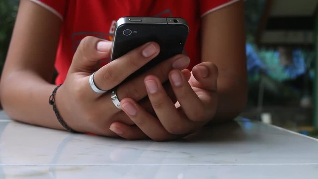 Closeup girl hands using touchscreen smartphone