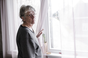 worried senior woman at home felling very bad