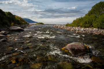The mouth of the river flows into the sea. Koni peninsula, the Sea of Okhotsk, Hindzha River,...