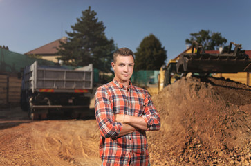 Young Worker at the Beginning of Construction. Standing and Looking  camera .