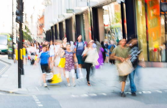Blurred image of walking people. Londoners and tourists walking in Oxford street, one of the main shopping destination of London