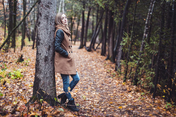 woman walking through the countryside in autumn time