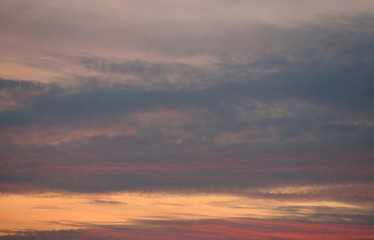 Orange, red, grey sky with clouds at sunset