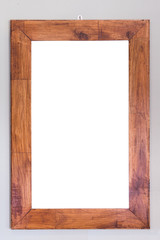Empty wooden frame hanging on the wall. Interior decoration