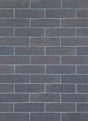 Naklejka premium Closeup surface brick pattern at old black stone brick wall textured background