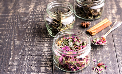 Fototapeta na wymiar Glass jar with herbal tea on wooden table 