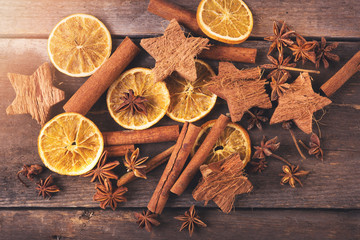 Fototapeta na wymiar christmas background with spices. top view on old wooden table