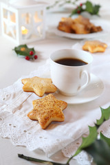  Christmas cookies, coffee, holly and  burning lantern