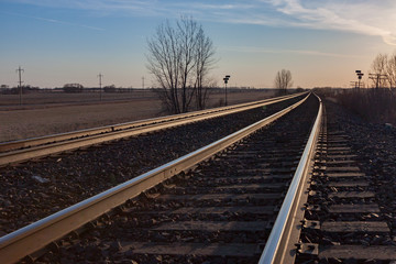 Fototapeta na wymiar Pair of Tracks Toward Horizon at Sunset