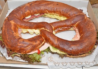 closeup of a large party pretzel filled with cold cuts and cheese 
