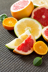 Citrus set of grapefruits and tangerines on a concrete gray back