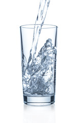 Pouring clear water in glass on white background