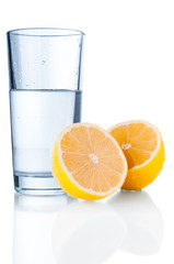 Glass with water and lemon closeup