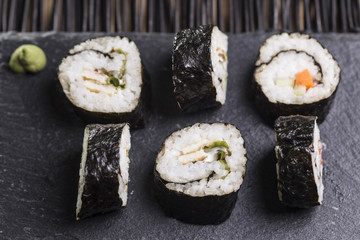 varietty of Sushi with lettuce, omelette, rice and nori outside