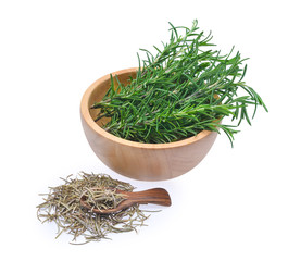 fresh and dried rosemary in wooden spoon and wooden bowl isolate