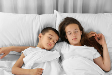 Fototapeta premium Brother and sister sleeping in bed