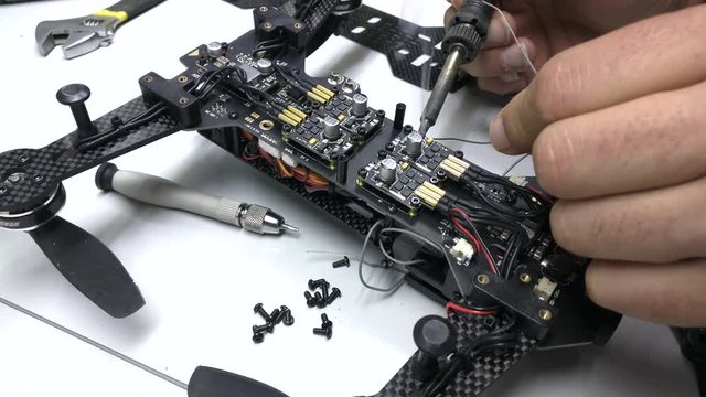 repair maintenance drone, control and welding, screwdrivers, tools, propellers