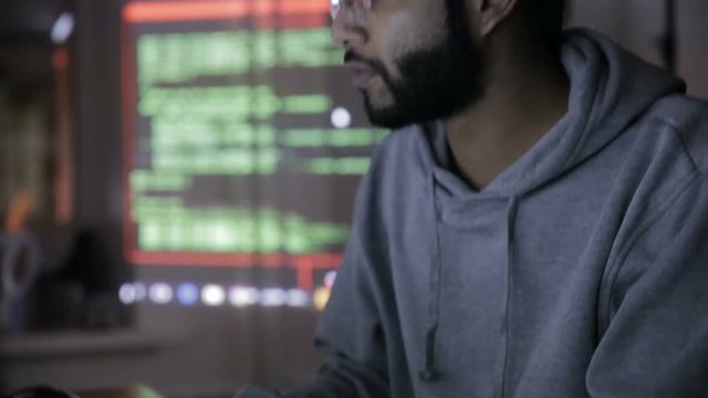 Computer hacker working in dark room. HD.