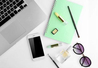 Workplace with laptop and women accessories, top view