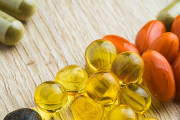 Herbal pills with healthy medical plant. Green leaf, alternative drug on wood ground