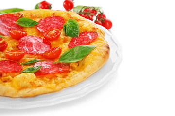 Tasty pizza and branch of cherry tomatoes on white background
