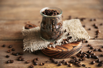 Coffee body scrub in glass jar on wooden table