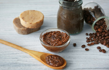 Coffee body scrub and soap on wooden table